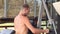 Side view of a young masculine Caucasian man doing exercise in a gym outdoor.