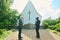 Side view of young pastor and senior male parishioner having talk in church yard