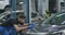 Side view of young serious focused service man checking examining vehicle tuning. Portrait of Caucasian auto mechanic