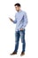 Side view of young smart casual business man reading message on cell phone