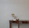 Sideboard in front of a grey wall and art objects