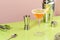 Sidecar alcoholic cocktail with cognac, liqueur, lemon juice and ice. Pink and green background, copy space