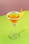 Sidecar classic alcoholic cocktail with cognac, liqueur, lemon juice and ice. Pink and green pop background, copy space