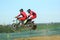 Sidecar motocross athletes jumping in the air