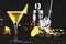 Sidecar, yellow cocktail with cognac, liqueur, lemon juice and ice. Black background, steel bar tools, copy space