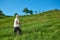 Sideview of old man walking with tracking sticks in mountains.