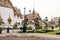 Sideview of one of the temples in Grand Palace, showing carefully pruned garden and clean sidewalk. Bangkok, Thailand.