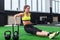 Sideview of a sporty woman doing l-sits exercises with bars in gym