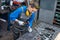 Sideview of worker woman marking piece of metal