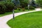 Sidewalk in the backyard of the mansion with green lawns.