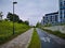 Sidewalk and bicycle path next to business garden corporate square