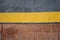 Sidewalk border yellow line on road, abstract background