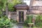 The sidewalk leads to a enter in house with Balinese sculptures in a tropical garden, island Bali, Indonesia