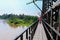 sidewalk and motorbike roadside path steel train bridge vintage. select focus with shallow depth of field