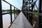 Sidewalk and motorbike roadside path steel train bridge vintage. select focus with shallow depth of field