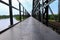 Sidewalk and motorbike roadside path steel train bridge vintage. select focus with shallow depth of field