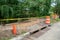 Sidewalk in the process of being replaced. Damaged concrete blocks have been removed and wooden boards placed to construct forms.