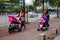 Sidewalk, women pushing baby carriages
