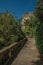 Sidewalk in wooded gardens of condos under sunny blue sky at Montmartre in Paris.