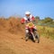 Sideward Motocross Racer creating the dust wind vortex behind him