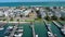 sideways aerial footage of Banks Channel with vast blue ocean water and lush green plants and trees, homes and boats, blue sky