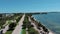 sideways aerial footage of a beautiful summer landscape at Hobie Island Beach Park with blue ocean water, ships sailing