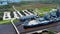 sideways aerial footage of the USS North Carolina surrounded by water and lush green trees and grass at Battleship North Carolina