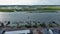 sideways aerial footage of wooden boat docks along Banks Channel with boat docks, docked boats, rippling blue water