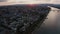 sideways move of a drone showing the Dome with the Rhine river with cargo ships and reflections on the water and old bridge in