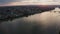 Sideways move of a drone showing Mainz with the Rhine river with cargo ships and reflections on the water and old bridge in