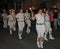 SIDMOUTH, DEVON, ENGLAND - AUGUST 10TH 2012: A troup of young lady Morris dancers hold their flaming torches as they takes part in