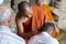 Siem Reap, Cambodia - 14 April 2018: buddhist monks rituals in Angkor Wat temple. Buddhist in orange clothes