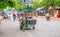 Siem Reap, Cambodia - 31 March 2018: Seller on a motorcycle in the city street. Mobile eatery on bike.