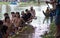 SIEM REAP, CAMBODIA - NOVEMBER, 2016: Traditional Asian boat racers resting by the edge of a river during practice