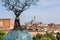 SIENA, ITALY - SEPTEMBER 23, 2023 - Terra Mater sculpture from Andrea Roggi, the cityscape of Siena in the background