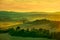 Siena, rolling hills on sunset. Rural landscape with cypress tre