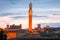 Siena skyline with famous Torre del Mangia at sunset. Tuscany. Italy.