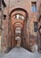 Siena, Tuscany, Italy: ancient alley with arches in the old town