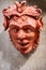 Siena, Tuscany, Italy, April 2018: Terracotta face mask shaped like a demon. Italian handmade art