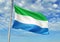 Sierra Leone flag waving with sky on background realistic 3d illustration