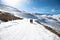 Sierra Nevada, Granada, Spain - 02/02/2020: Two walkers on mountain road in snow