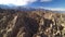 Sierra Nevada Mountains and Mt Whitney from Alabama Hills Desert and Rock Fins Aerial Shot Forward Tilt Up