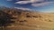 Sierra Nevada Mountains and Mt Whitney from Alabama Hills Desert and Rock Formation Aerial Shot Rotate Right Sunlight