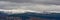 Sierre Nevada mountain tops with snow under a grey sky