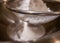 Sieving flour powder into a bowl.