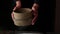 Sieving whole wheat flour through old sieve by woman\'s hands