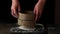 Sieving whole wheat flour through old sieve by woman\'s hands
