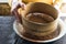 Sifting cocoa into a bowl with flour view from the side