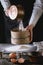 Sifting flour by female hands