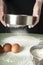 Sifting flour through a sieve